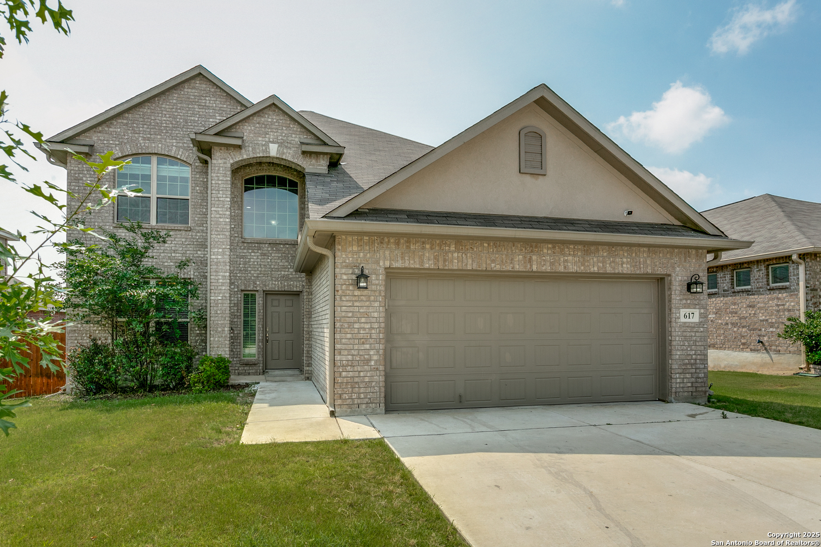 a front view of a house with a yard and garage