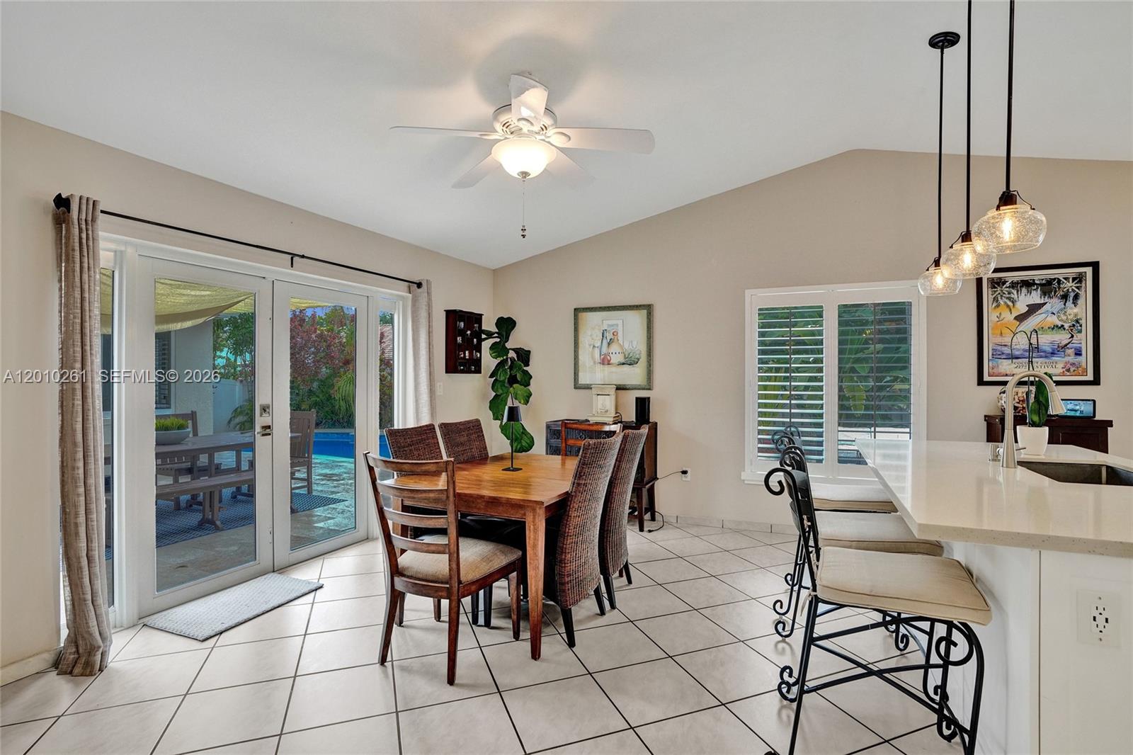 13621 Southwest 18th Street Miramar, FL 33027 - Photo 16 of 45 a dining room with furniture a chandelier and window
