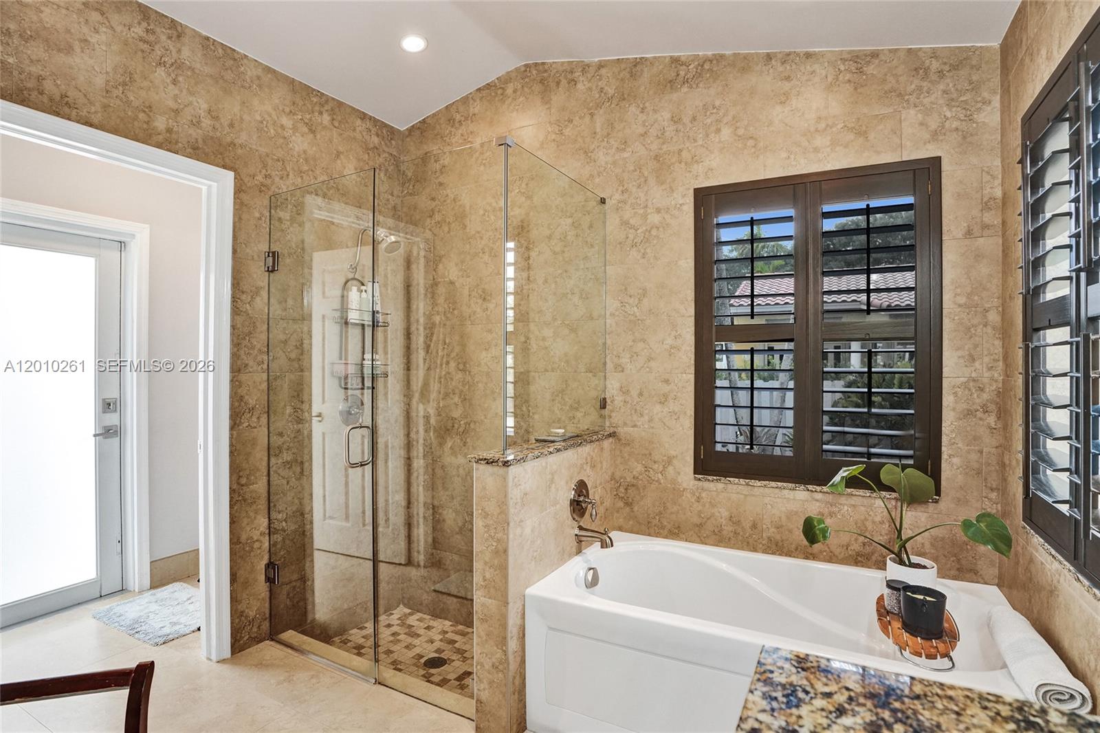 13621 Southwest 18th Street Miramar, FL 33027 - Photo 21 of 45 a bath room with a bath tub and a shower