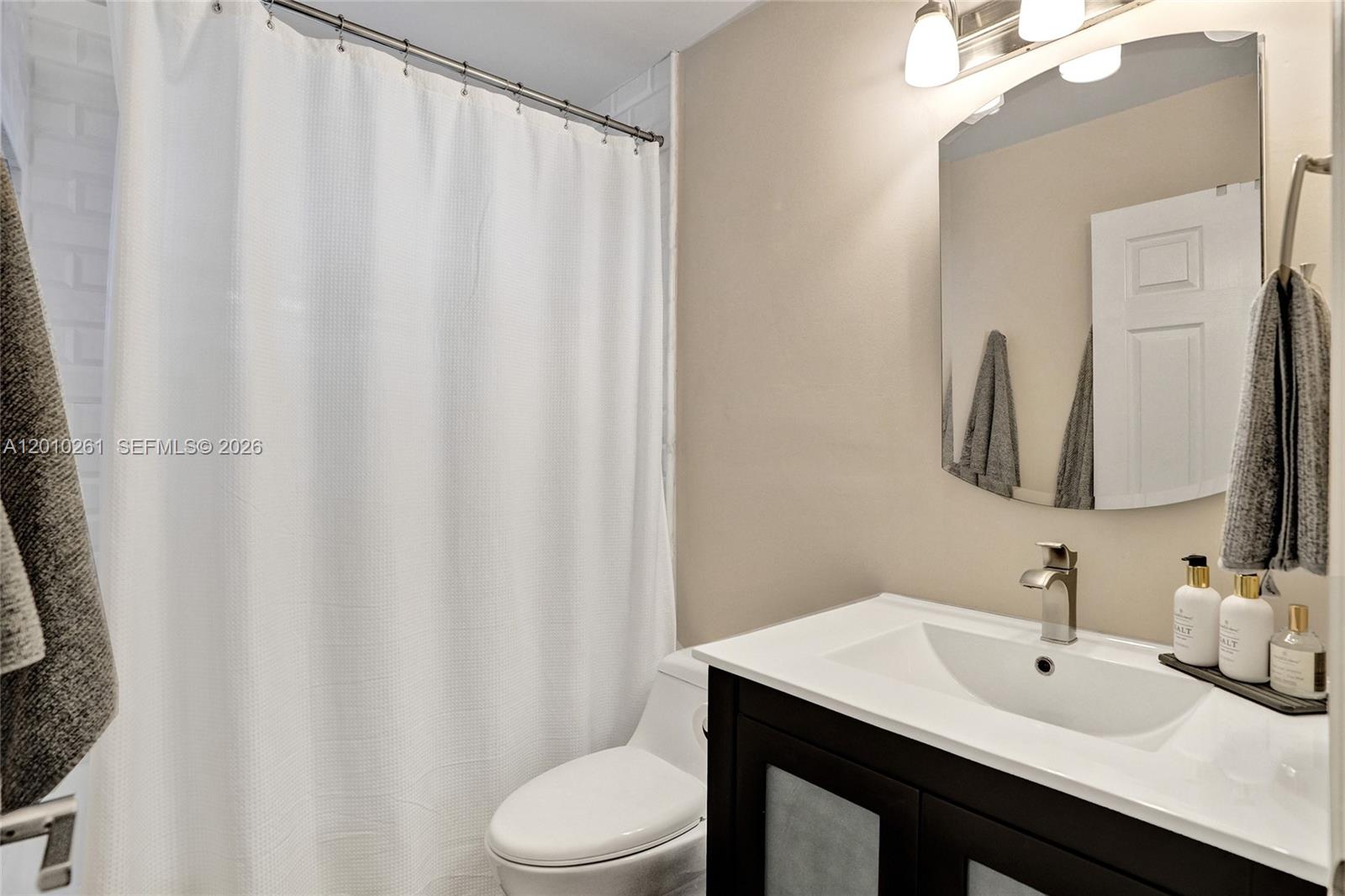13621 Southwest 18th Street Miramar, FL 33027 - Photo 26 of 45 a bathroom with a sink vanity mirror and toilet