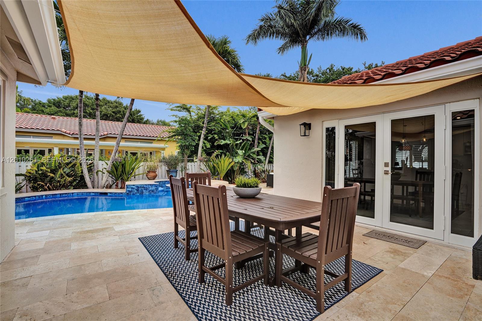 13621 Southwest 18th Street Miramar, FL 33027 - Photo 31 of 45 a view of a patio with a table chairs and a potted plant