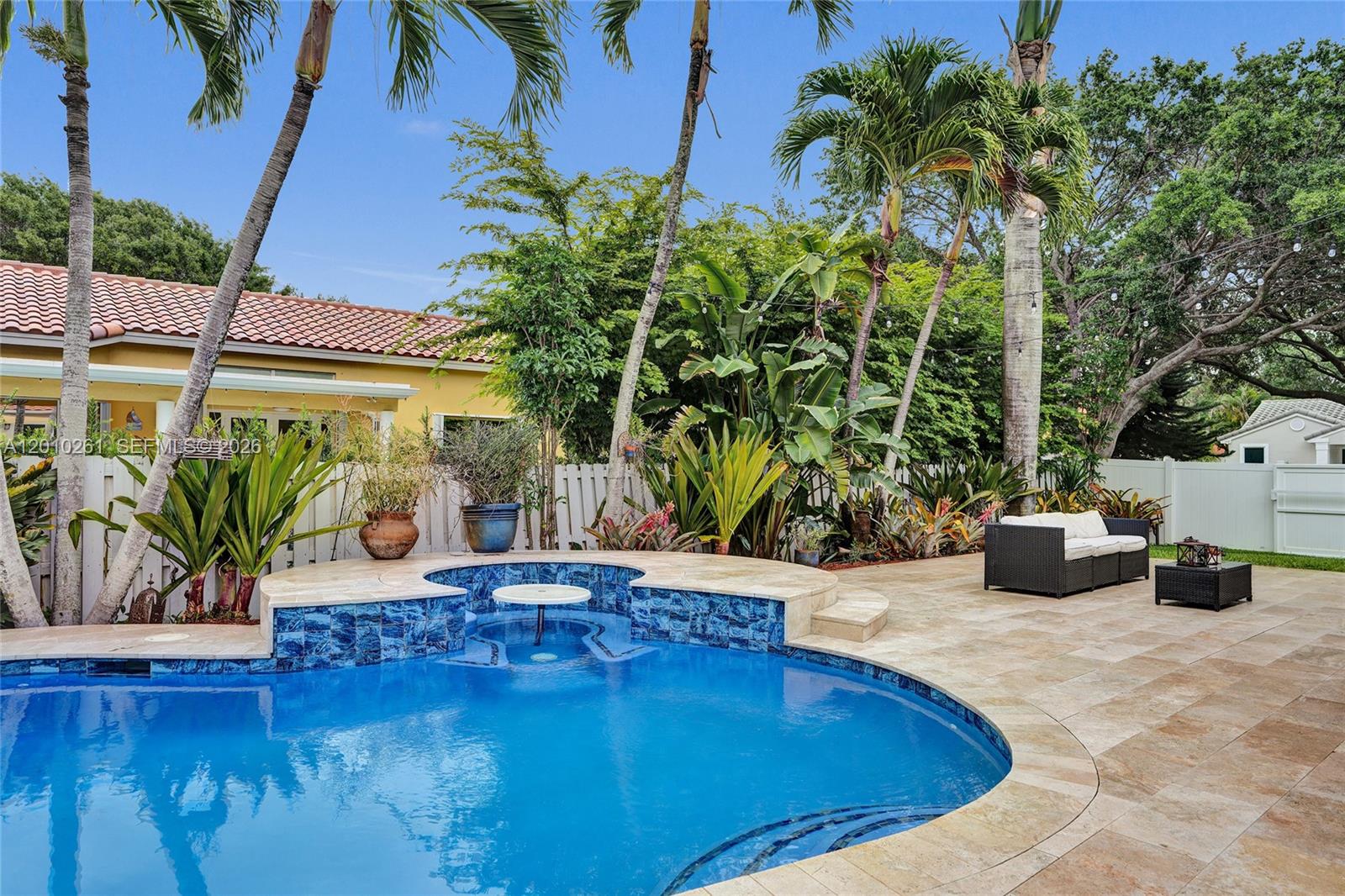 13621 Southwest 18th Street Miramar, FL 33027 - Photo 32 of 45 a view of a swimming pool with potted plants and palm trees
