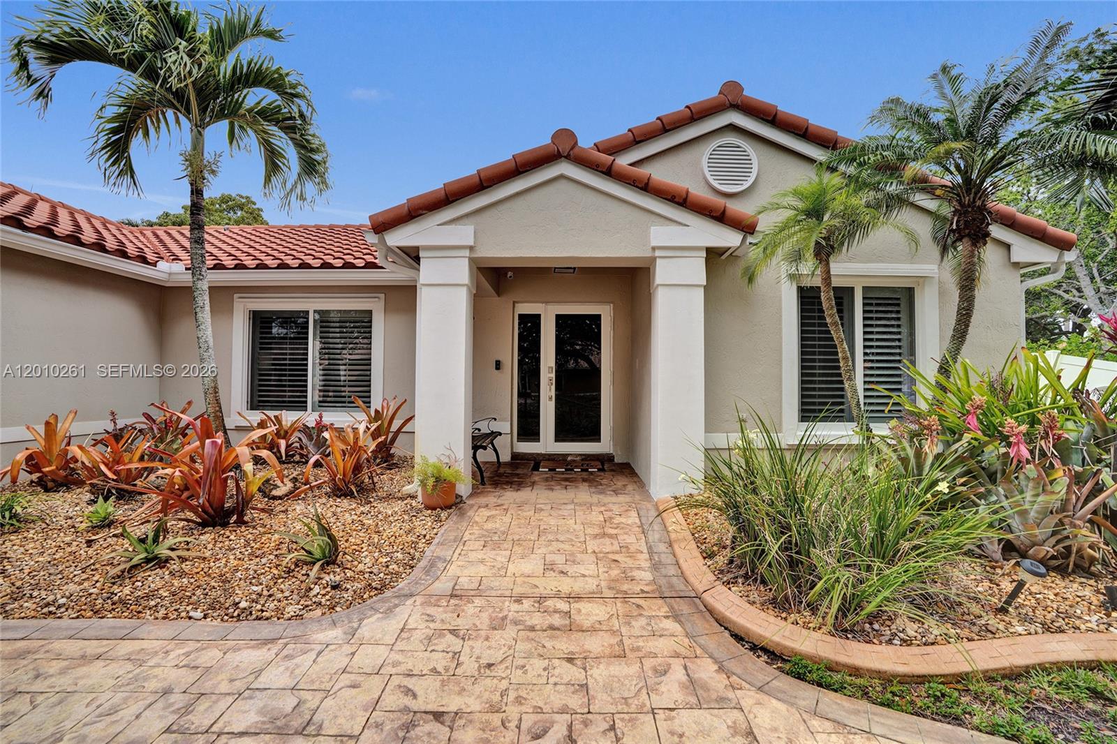 13621 Southwest 18th Street Miramar, FL 33027 - Photo 4 of 45 a front view of a house with garden