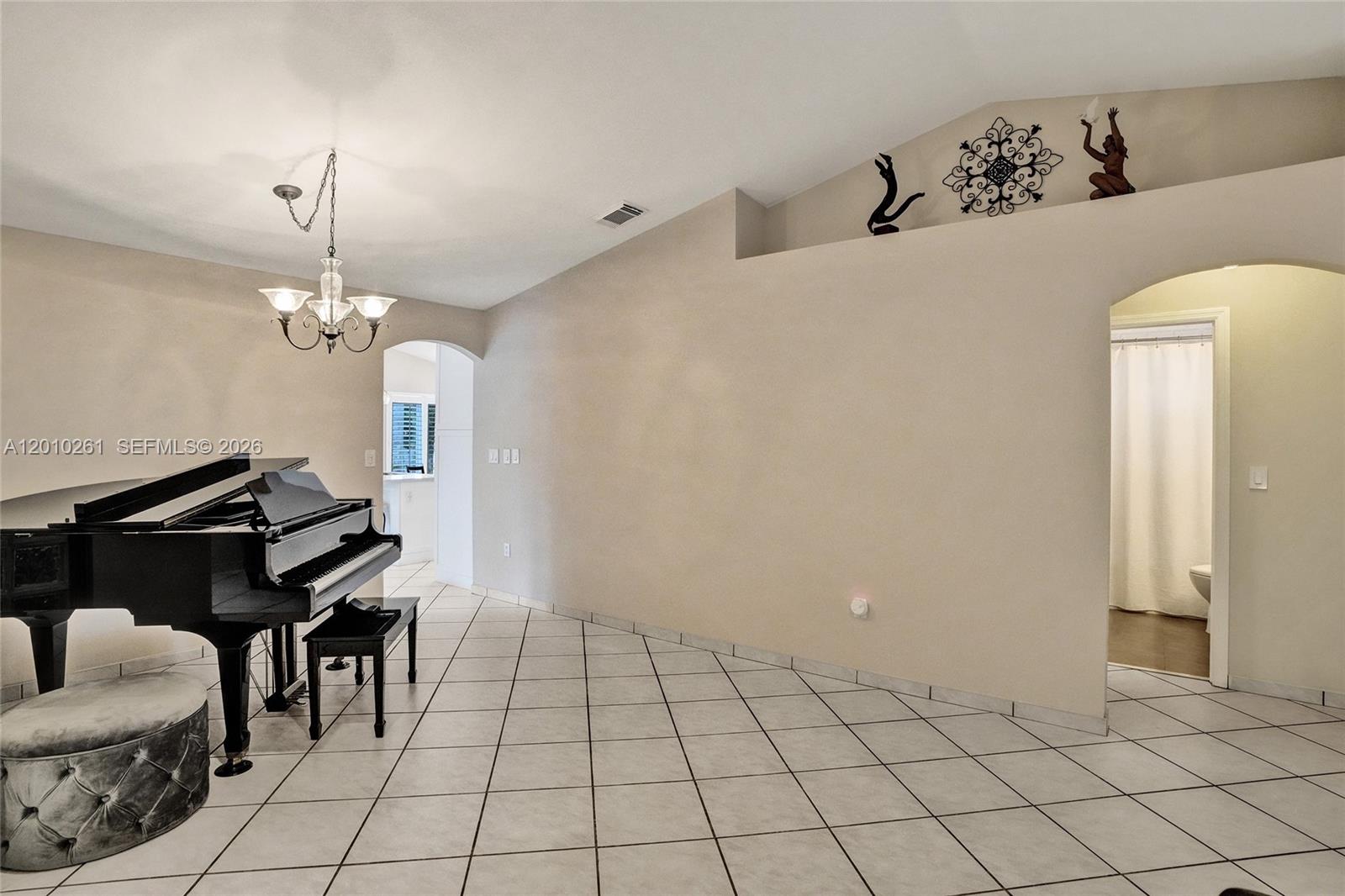 13621 Southwest 18th Street Miramar, FL 33027 - Photo 10 of 45 a dining room with furniture and a chandelier