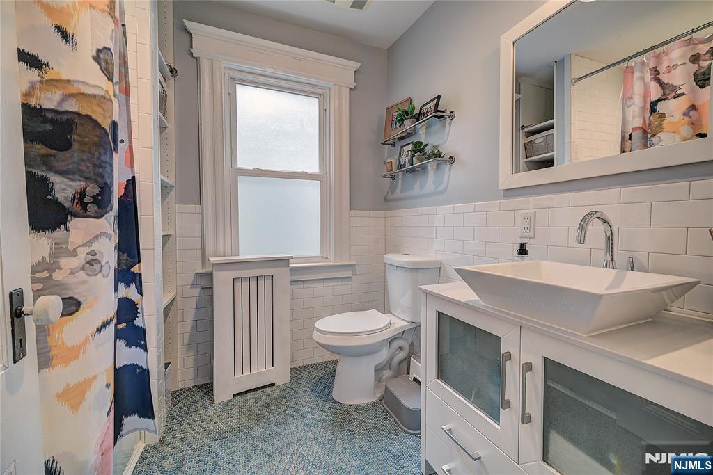 43 Llewellyn Avenue Bloomfield, NJ 07003 - Photo 13 of 25 a bathroom with a sink toilet and vanity