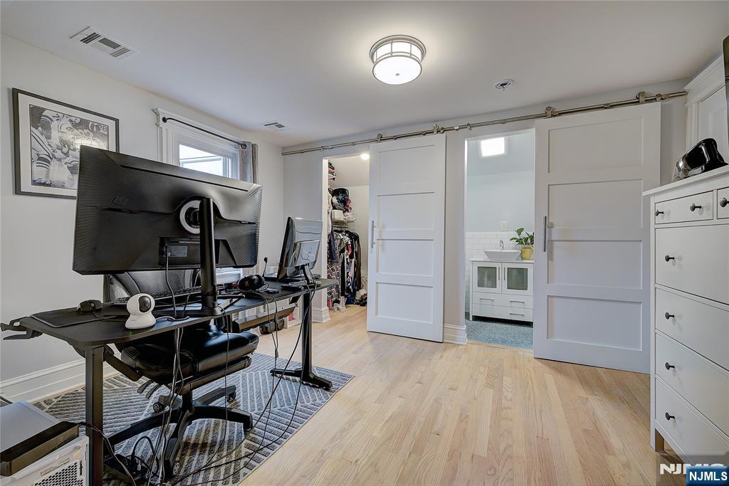 43 Llewellyn Avenue Bloomfield, NJ 07003 - Photo 18 of 25 a living room with furniture a flat screen tv and a refrigerator