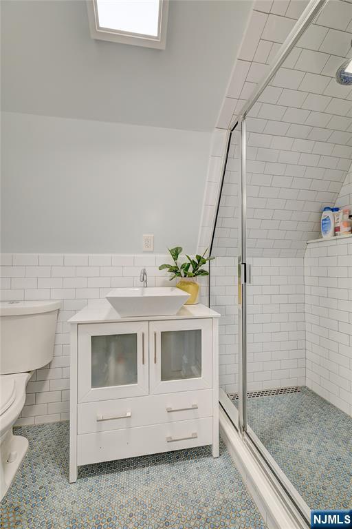 43 Llewellyn Avenue Bloomfield, NJ 07003 - Photo 19 of 25 a bathroom with a sink and mirror