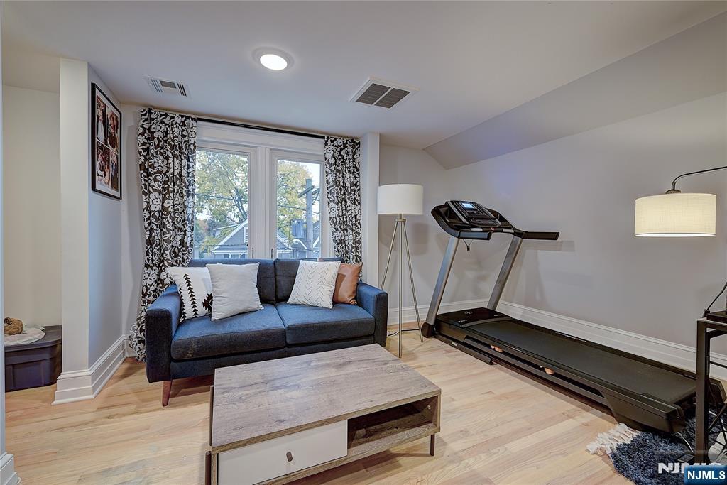 43 Llewellyn Avenue Bloomfield, NJ 07003 - Photo 20 of 25 a living room with furniture gym equipment and a large window