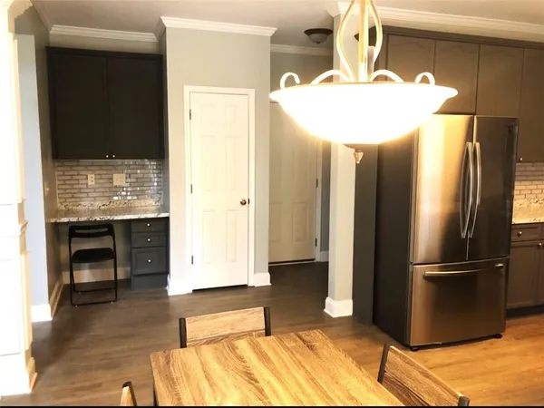 a kitchen with stainless steel appliances granite countertop a refrigerator and a stove