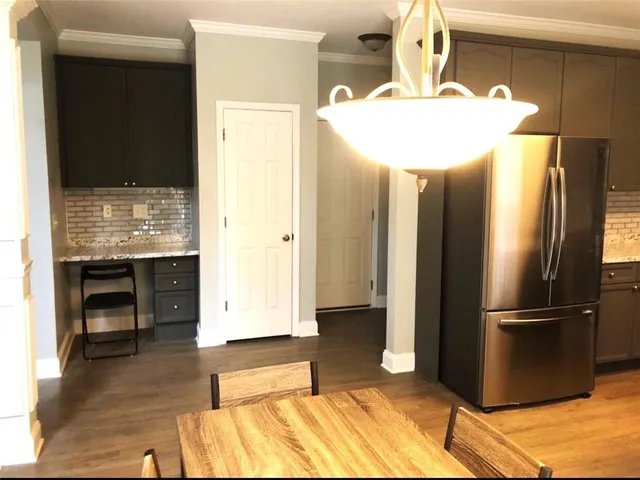 a kitchen with stainless steel appliances granite countertop a refrigerator and a stove