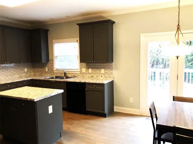 a kitchen with a sink cabinets and a granite counter top