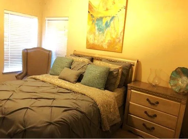 a bed sitting in a bedroom next to a window