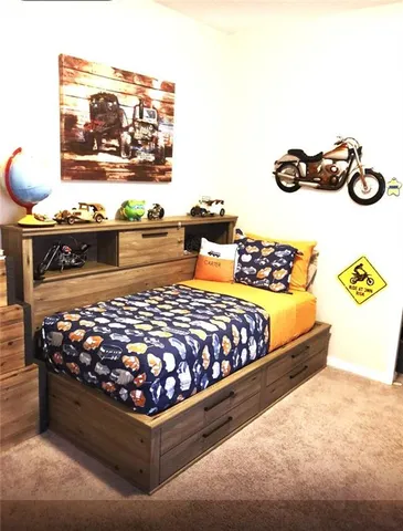 a large bed sitting in a bedroom next to a wall