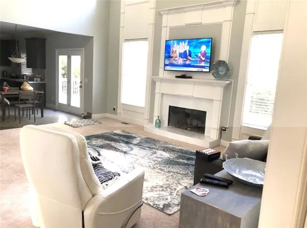 a living room with furniture a fireplace and a flat screen tv