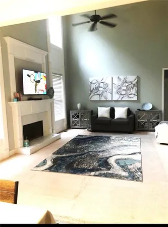 a view of a living room a chandelier and fireplace