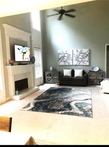 a view of a living room a chandelier and fireplace
