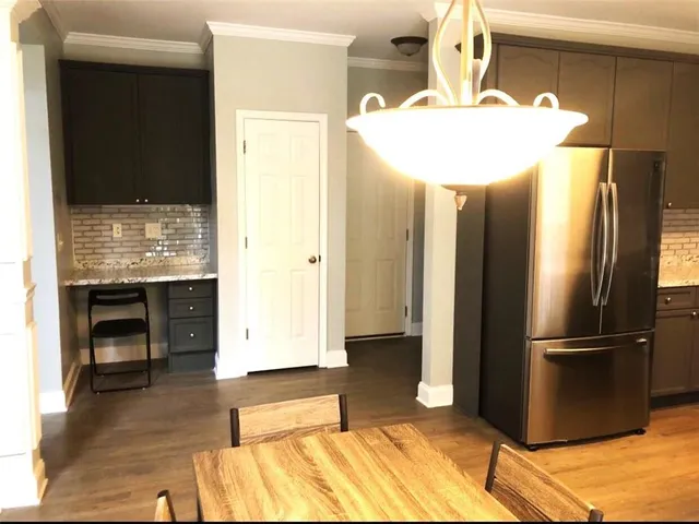 a kitchen with stainless steel appliances granite countertop a refrigerator and a stove