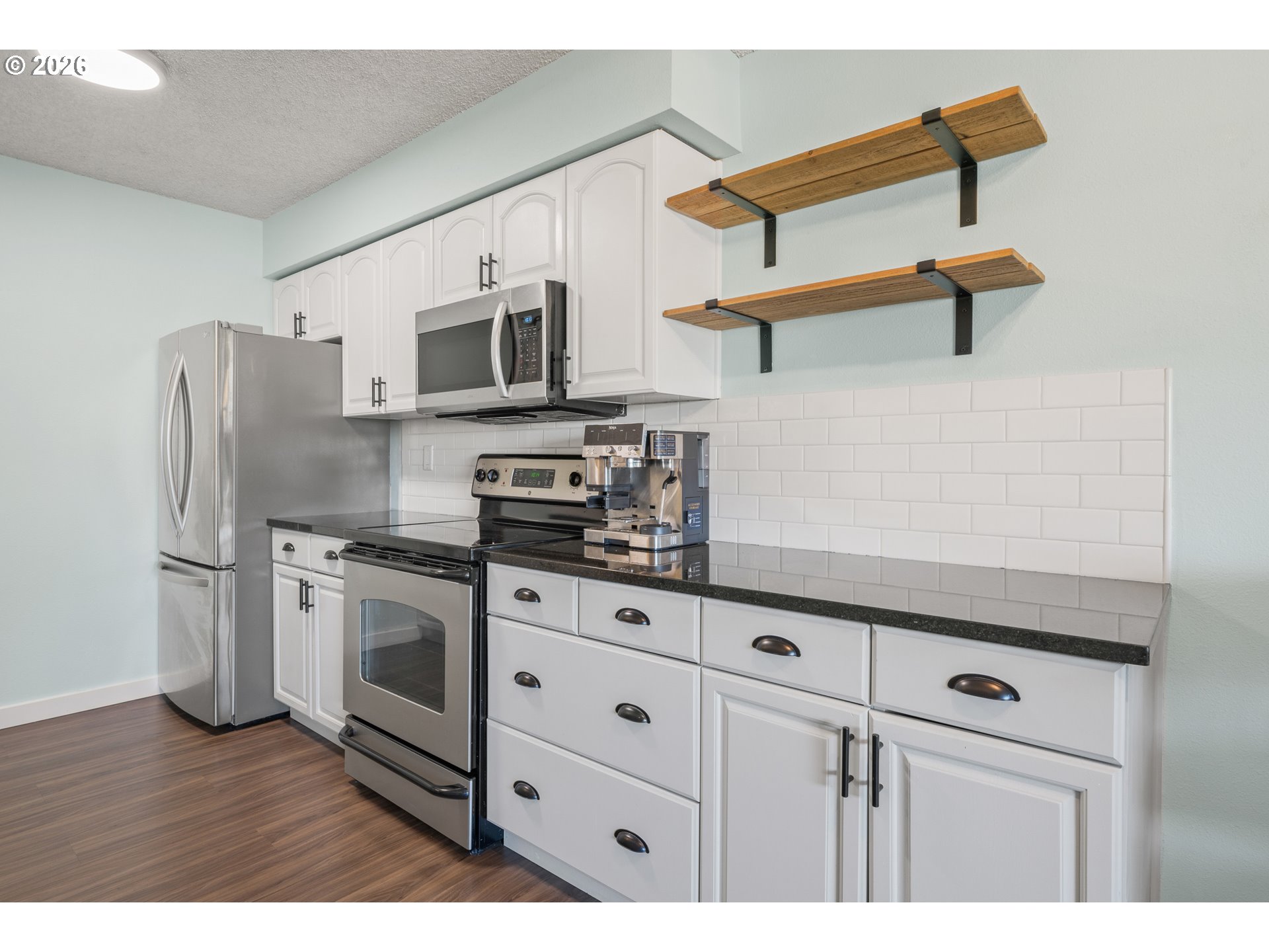 2727 Gateway Street, Unit 18 Springfield, OR 97477 - Photo 14 of 34 a kitchen with stainless steel appliances granite countertop a refrigerator and a stove top oven