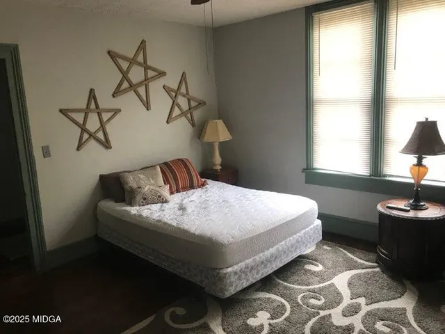 a bedroom with a bed and dresser
