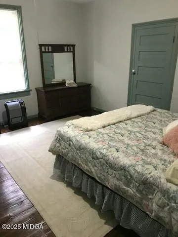 a bedroom with a bed and a lamp on table