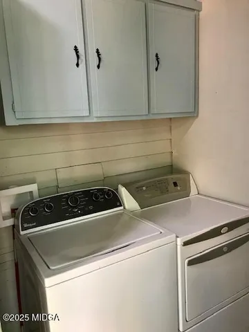 a bedroom with a bed and a television