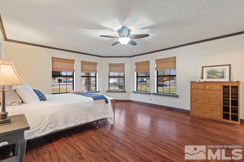 4060 Cimarron Road Fallon, NV 89406 - Photo 12 of 22 a spacious bedroom with a bed and wooden floor