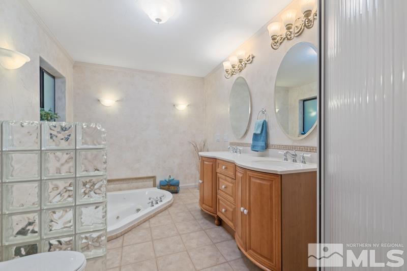4060 Cimarron Road Fallon, NV 89406 - Photo 14 of 22 a bathroom with a granite countertop sink a toilet and bathtub