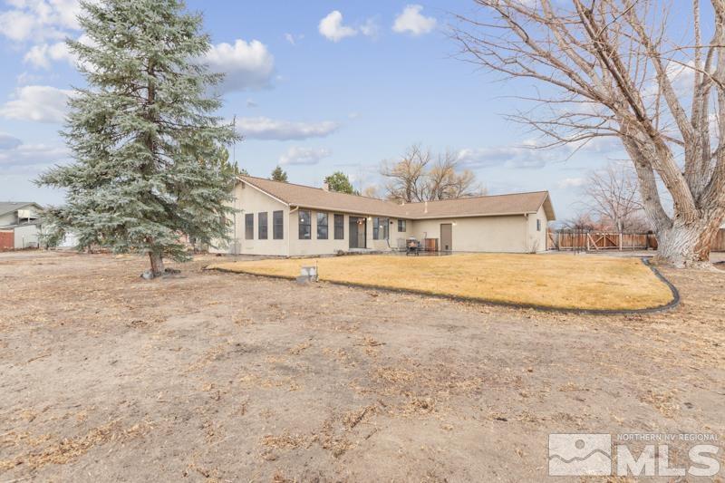4060 Cimarron Road Fallon, NV 89406 - Photo 20 of 22 a view of house with yard and trees in the background