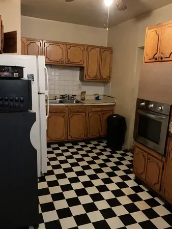 a kitchen with stainless steel appliances granite countertop a refrigerator and a stove top oven