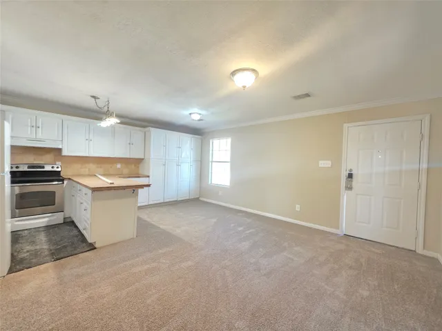 a large kitchen with stainless steel appliances granite countertop a stove a sink and a refrigerator