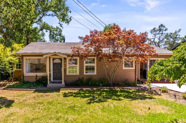a front view of a house with a yard