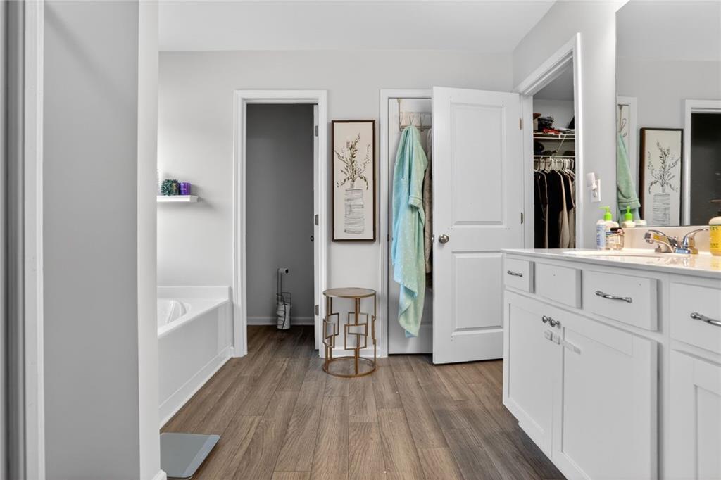 594 Summit Point Canton, GA 30114 - Photo 14 of 32 a hallway with white cabinets and wooden floor