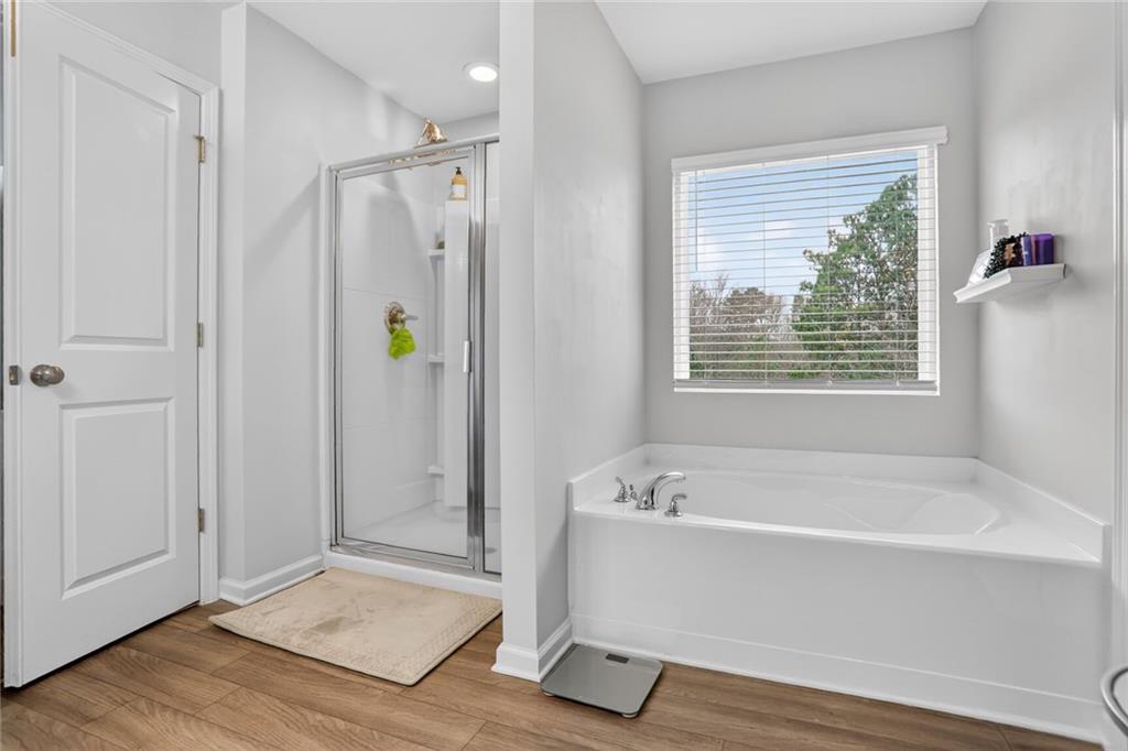 594 Summit Point Canton, GA 30114 - Photo 16 of 32 a bathroom with a bathtub and shower