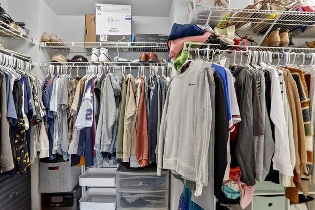 a view of walk in closet with clothes