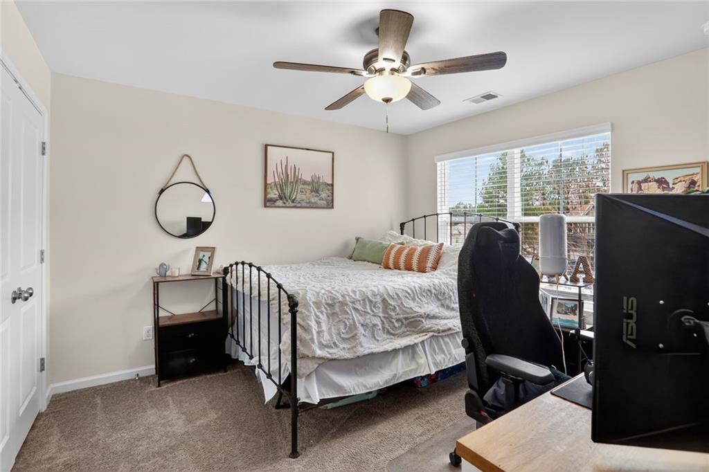 594 Summit Point Canton, GA 30114 - Photo 18 of 32 a bedroom with a bed and a chandelier