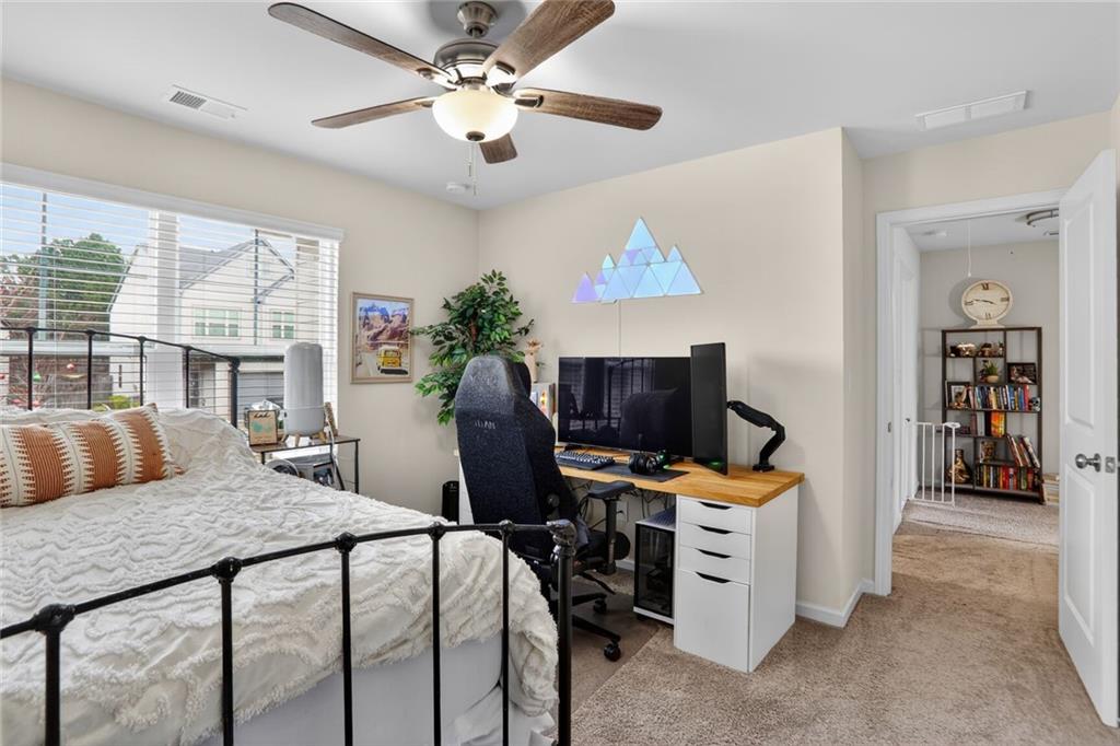 594 Summit Point Canton, GA 30114 - Photo 19 of 32 a bedroom with a bed and a chandelier