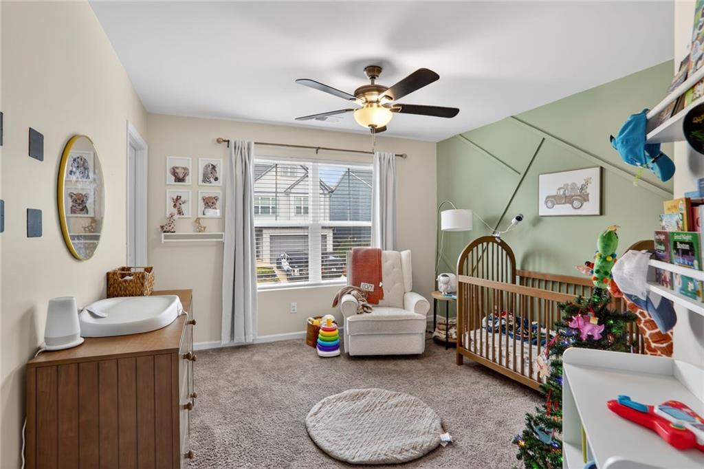 594 Summit Point Canton, GA 30114 - Photo 21 of 32 a bedroom with furniture a rug potted plant and a window