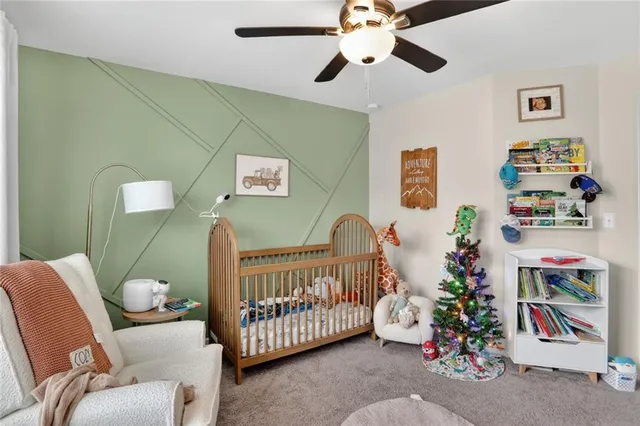 a bedroom with furniture and a chandelier fan