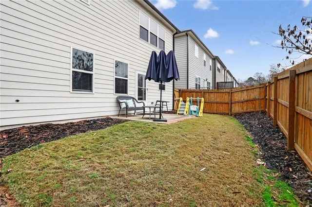 a view of house with backyard and deck