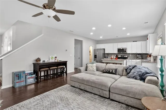 a living room with furniture and kitchen view