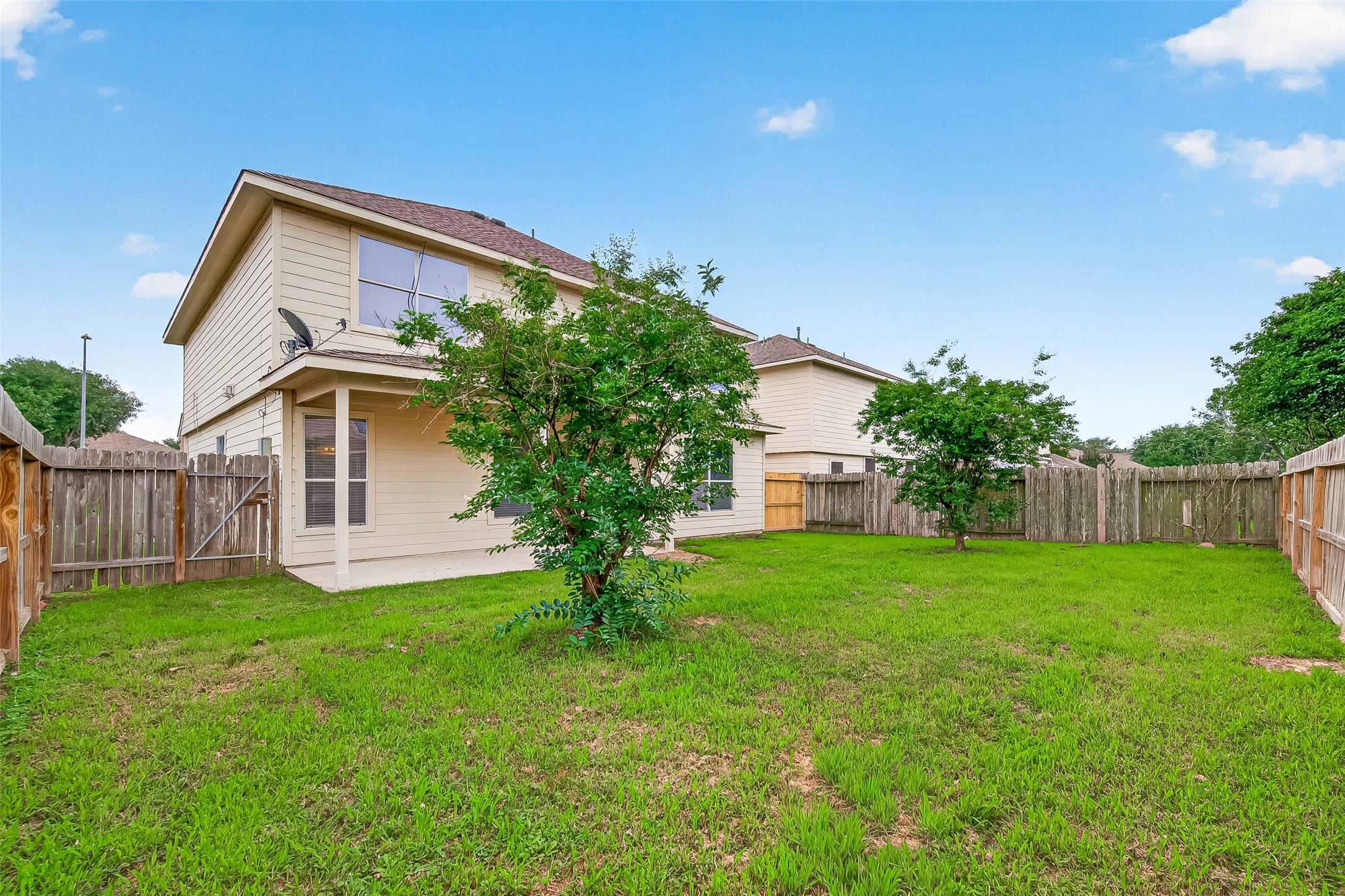 21327 Bella Flora Court Spring, TX 77379 - Photo 49 of 50 a view of a house with a yard and a large tree