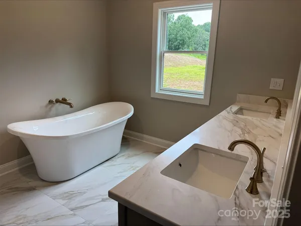 a white tub sitting next to a window
