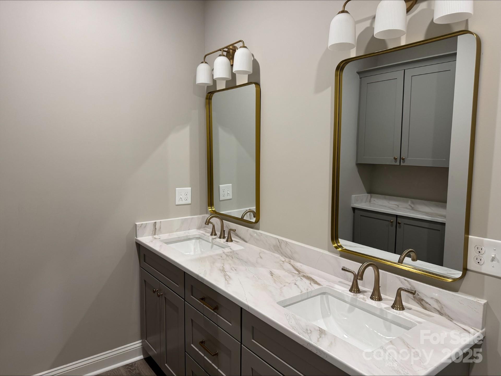 4047 Stadler Drive Northeast Conover, NC 28613 - Photo 2 of 12 a bathroom with double vanity sinks and a mirror