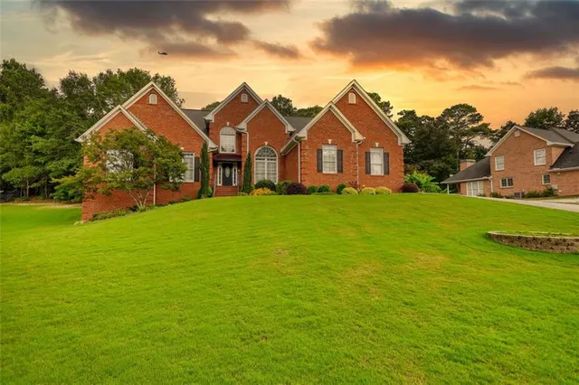 an aerial view of a house with outdoor space and a lake view