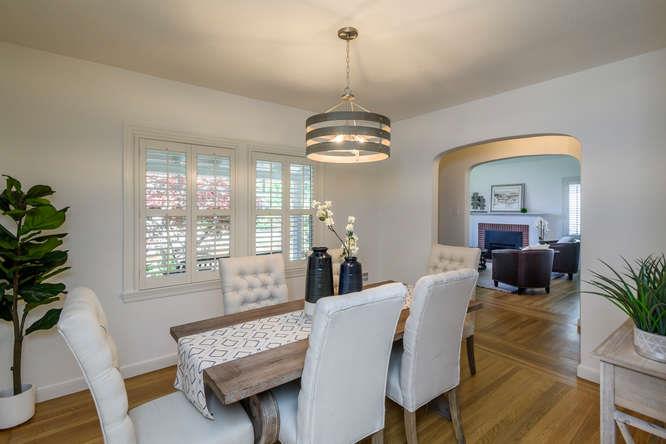 404 Dwight Road Burlingame, CA 94010 - Photo 11 of 33 a living room with furniture a chandelier and a window