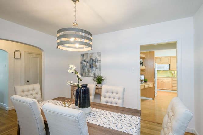 404 Dwight Road Burlingame, CA 94010 - Photo 12 of 33 a dining room with wooden floor chandelier and a livingroom