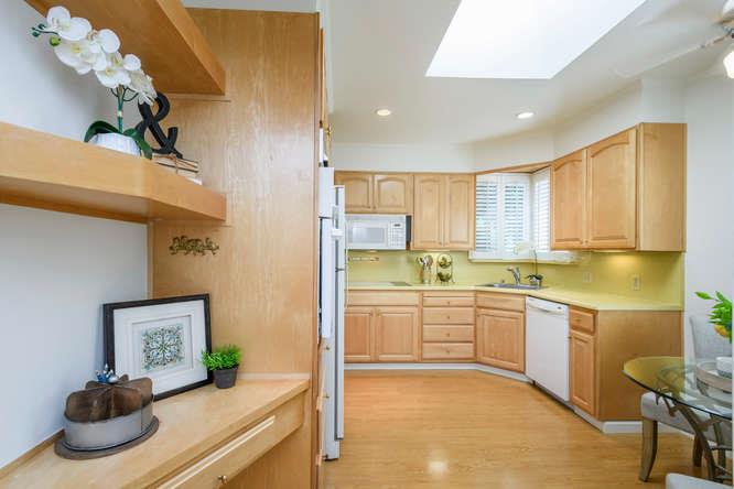 404 Dwight Road Burlingame, CA 94010 - Photo 13 of 33 a kitchen with a sink cabinets and window