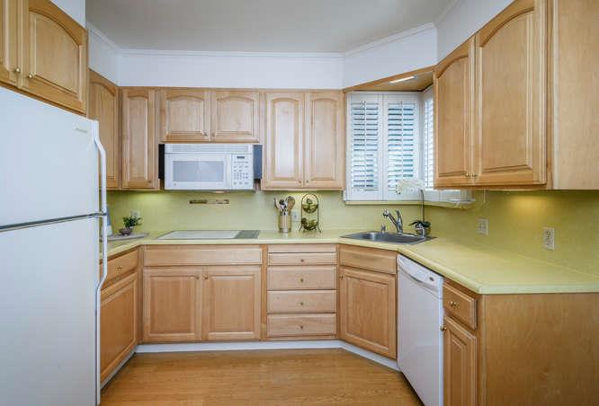 404 Dwight Road Burlingame, CA 94010 - Photo 15 of 33 a kitchen with a sink stove and cabinets