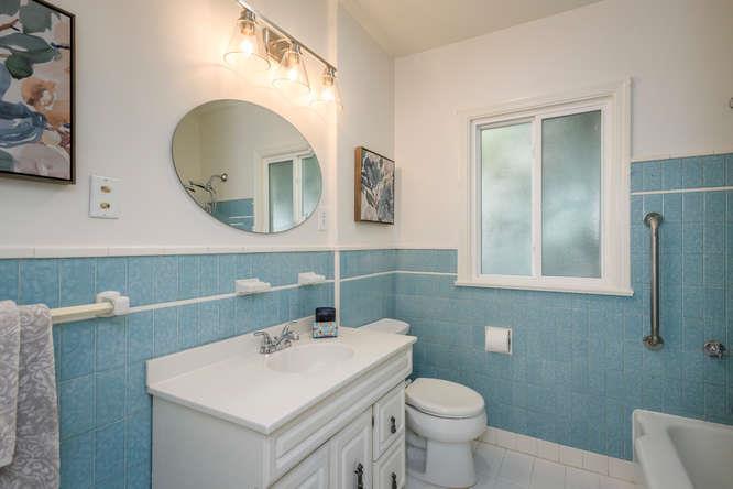 404 Dwight Road Burlingame, CA 94010 - Photo 19 of 33 a bathroom with a toilet a sink and mirror