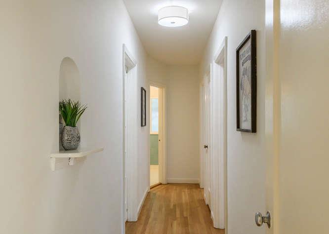 404 Dwight Road Burlingame, CA 94010 - Photo 21 of 33 a view of a hallway with wooden floor and a bathroom
